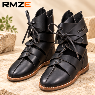 RMZE black strappy medieval-inspired boots with textured upper and lace-up detailing